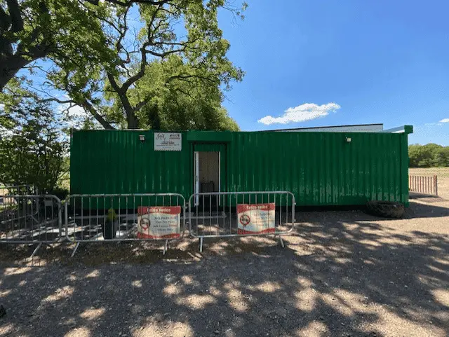 Outside of green gym container, facing gym